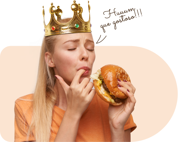 Imagem de uma mulher comendo um hambúrguer